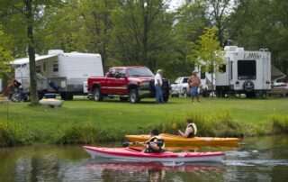 campground with RV and kayakers