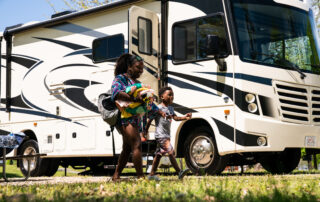Family walking to the beach past an RV
