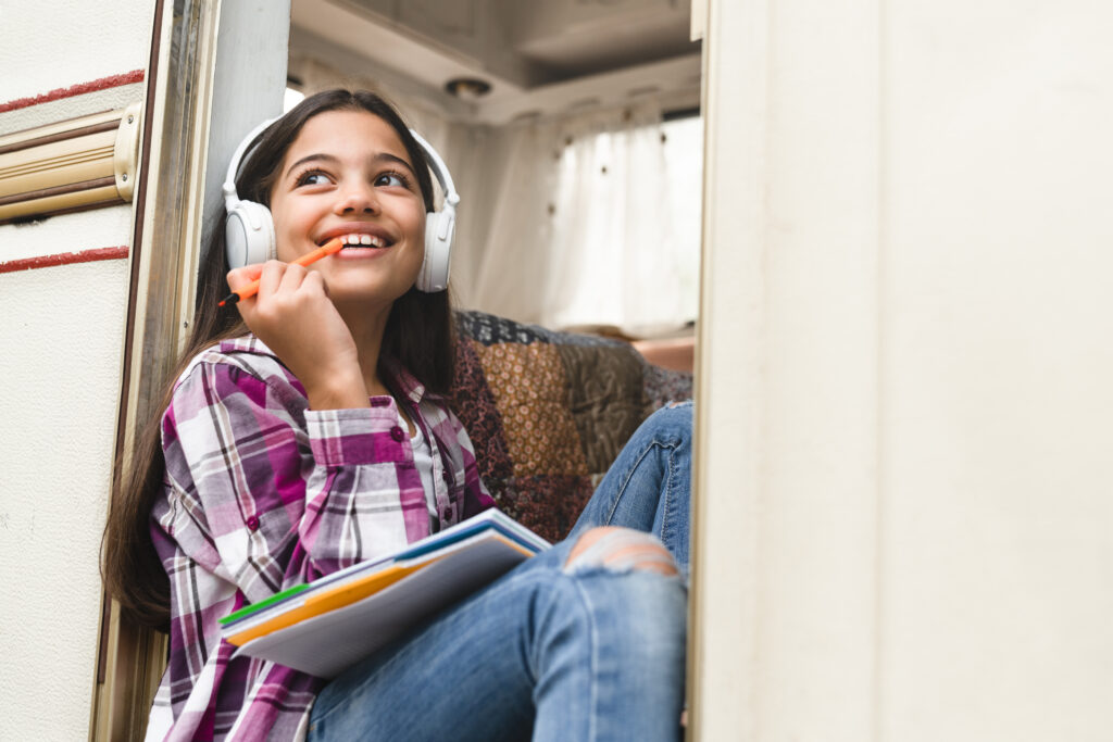 Preteen girl listening to music while RVing