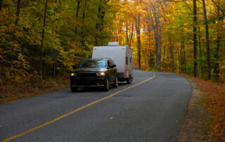 SUV towing an RV in the fall