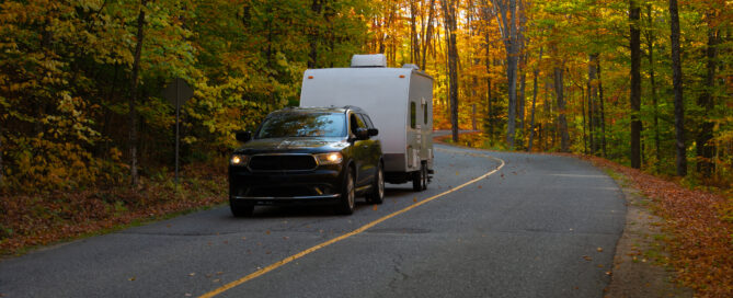 SUV towing an RV in the fall