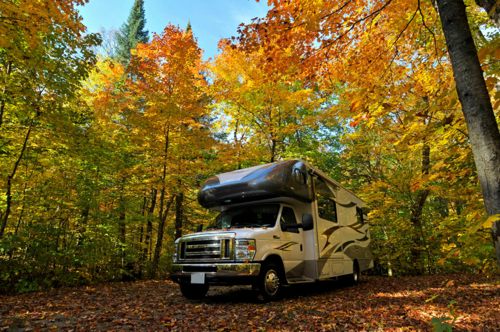 Class C motorhome at a campground in the fall